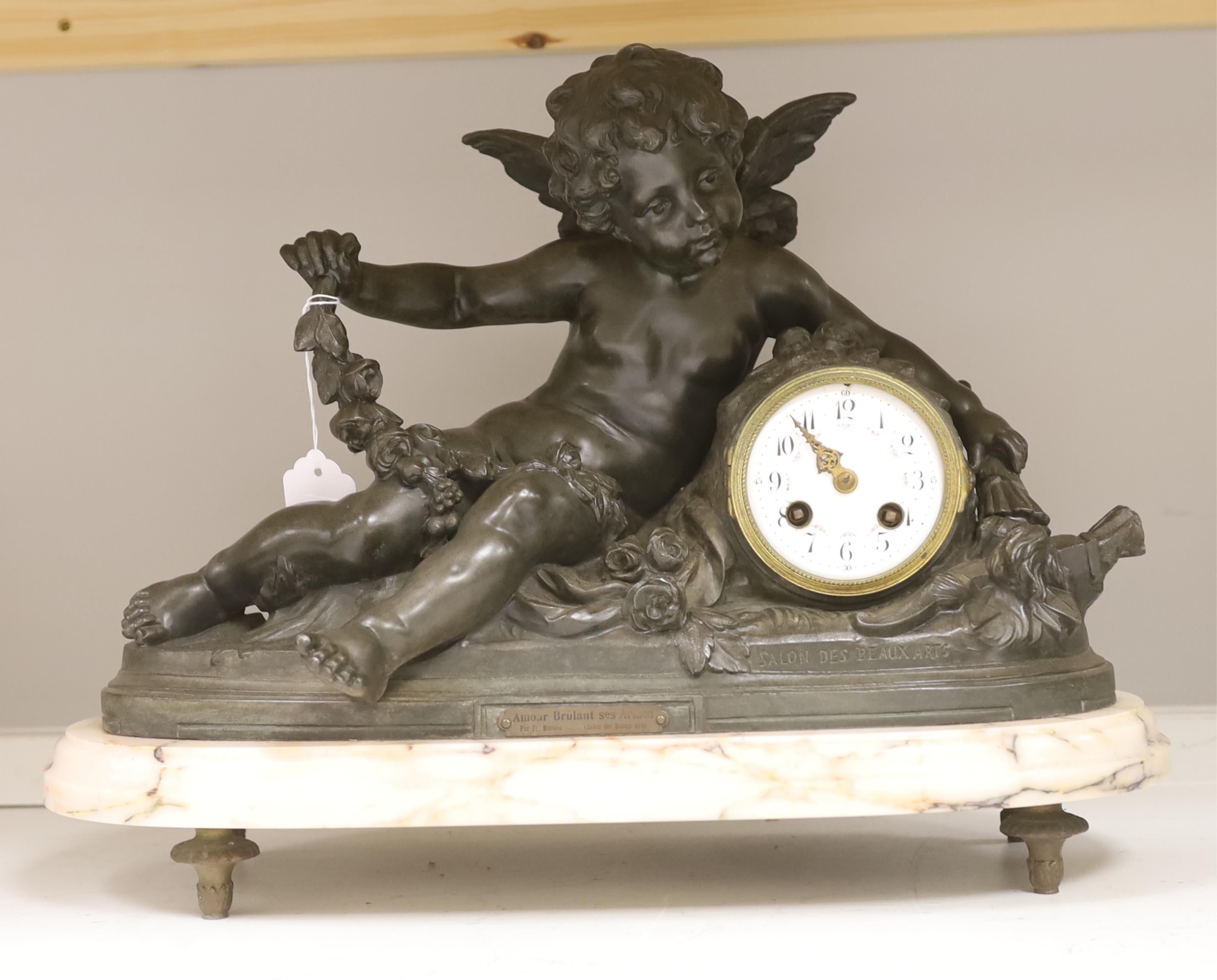 After Francois Hippolyte Moreau (French, 1832-1926), a late 19th century bronze cherubic mantel clock on marble base, ‘Amour Brûlant Ses Armes’, no key or pendulum, 34cm high. Condition - clock glass missing, not known i